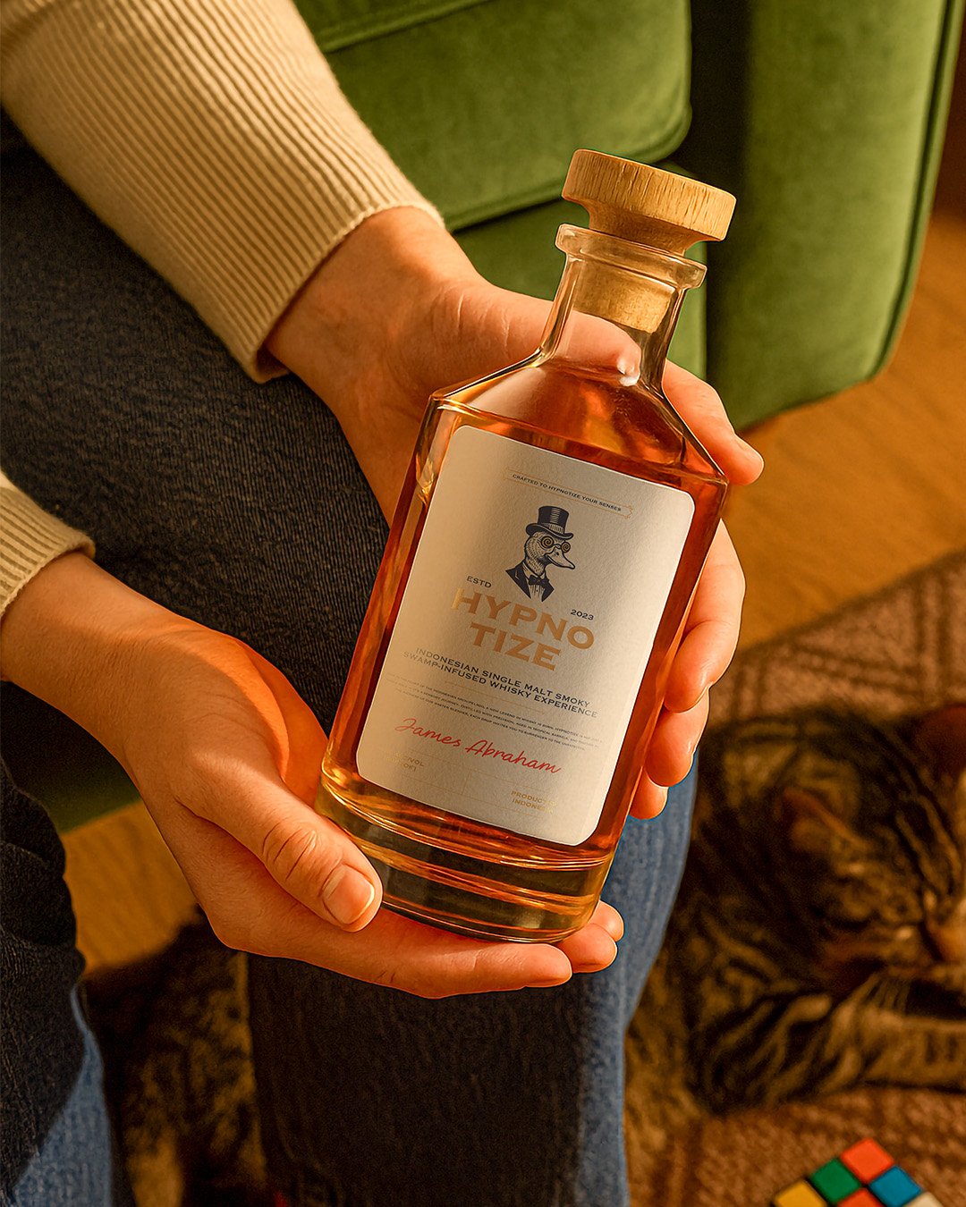 Hypnotize social post: bottle held at home with a cat in the background