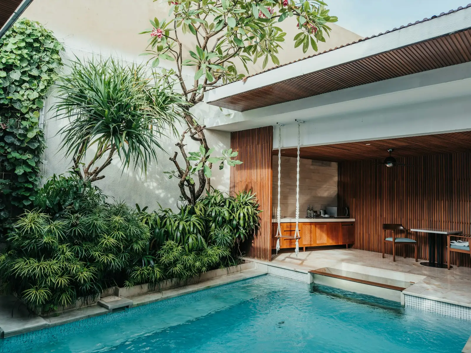 A villa courtyard with a pool and a small open kitchen